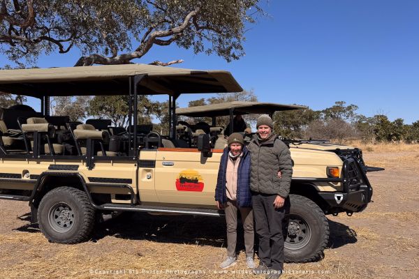 Stu and Ann by a Wild4 vehicle by Stu Porter, Wild4 Photography Tours